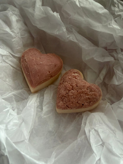 Two heart-shaped soaps on crumpled white paper